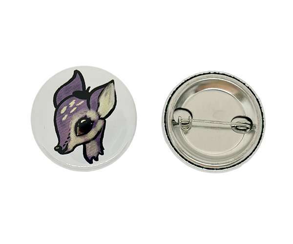Two 32mm Button Badges; one displays a cartoon purple deer head, whilst the other reveals the back with a metal pin fastening.