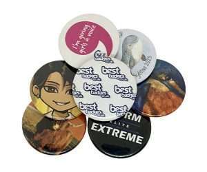 A set of seven 38mm button badges featuring assorted designs—ranging from animals and text to logos and a cartoon character—displayed in a circular arrangement on a white background.