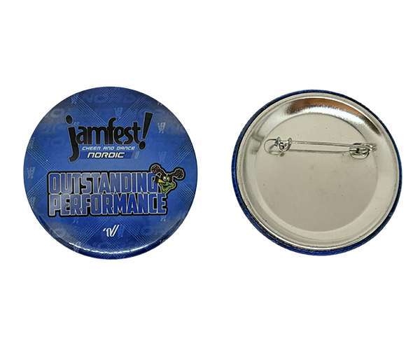 Two round blue 58mm Button Badges are shown; one displays the text "jamfest! Cheer and Dance Nordic Outstanding Performance," while the other reveals the reverse side with a metal pin fastening.