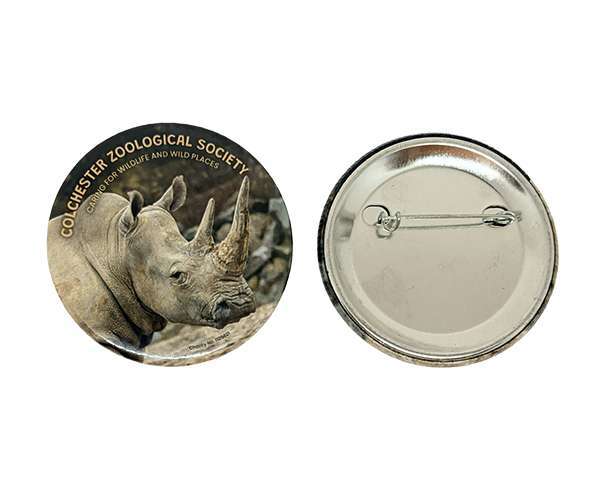 A 58mm Button Badge featuring a rhinoceros design on the front with a standard metal pin clasp on the reverse, both displayed side by side against a white background.