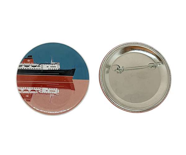 Two 58mm Button Badges: one features a ship reflected on water, whilst the other shows the plain metal back and pin mechanism.