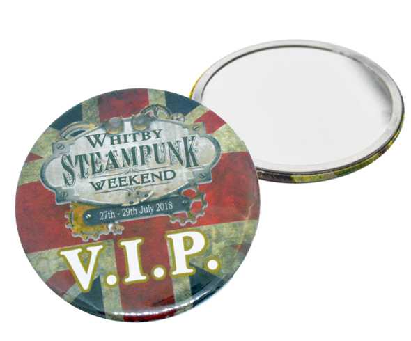 Two round badges, one showing "Whitby Steampunk Weekend 27th-29th July 2018 V.I.P." on a Union Jack background, the other flipped to reveal the blank back.