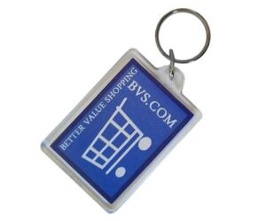A rectangular keychain with a blue label displaying a shopping cart icon and the text "BETTER VALUE SHOPPING BVS.COM.