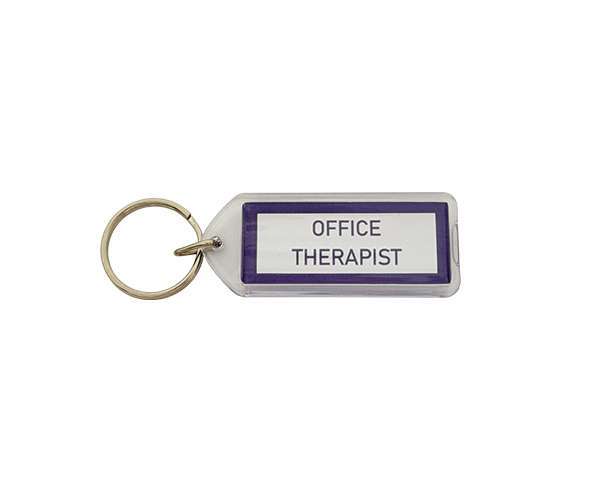 An Acrylic Keyring (50mm x 20mm Lozenge) featuring a rectangular design with a metal ring, a white label bordered in purple, and the text “OFFICE THERAPIST.”.