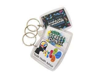 Three acrylic keyrings (45mm x 35mm) featuring colourful health-themed designs and text—“Annual Performer”, “Street Dance”, and “Youth Health Advice”—on a white background.