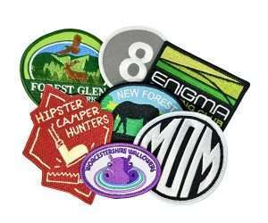 The Embroidered Badges set includes seven colourful patches featuring a variety of designs and text, such as animals, landscapes, and words.