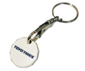 A metal keychain with a round white tag displaying the blue text "TOYO TIRES" and a clasp attached to a keyring.