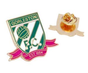 Enamel pin badge displaying the 'Gorleston F.C.' logo and 'EST 1884', with pink, green, gold, and white colors; the back of the badge shows a metal butterfly clutch pin.