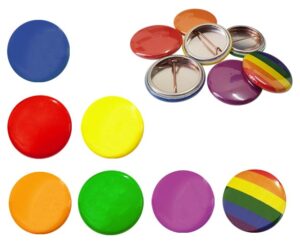 A collection of colorful round buttons, including solid colors and a rainbow-striped one, with some buttons displayed face up and others showing the back side.