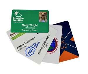 Five Photo ID Cards are spread out, with the top card displaying a photo, the name “Molly Wright,” and “Ormiston Families.” Other Photo ID Cards show different names and organisations.