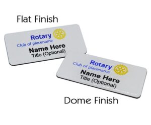Two rectangular Rotary name badges labeled "Flat Finish" and "Dome Finish," both displaying sample text for name and title, with the Rotary logo.
