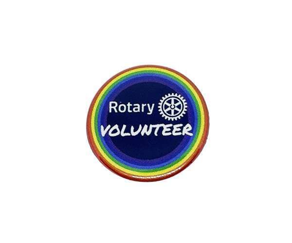 Rotary Volunteer Badges: Circular badge featuring a rainbow border, a dark blue centre with the Rotary logo, and “VOLUNTEER” in white text.