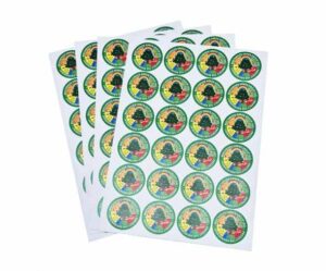 Four sheets of round, colorful stickers featuring a logo with a silhouette of a person and text on a yellow and green background.