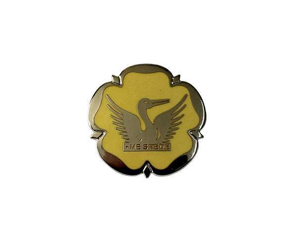 A Traditional Hard Enamel Badge shaped like a flower with a yellow centre, featuring a crane with outstretched wings and the text "THE SPEED.