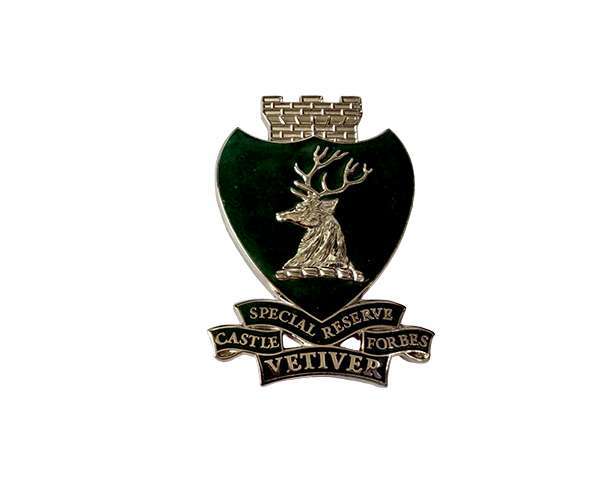 A Traditional Hard Enamel Badge featuring a green shield with a stag's head, topped by a brick crown, and a banner reading "Special Reserve Castle Forbes Vetiver.
