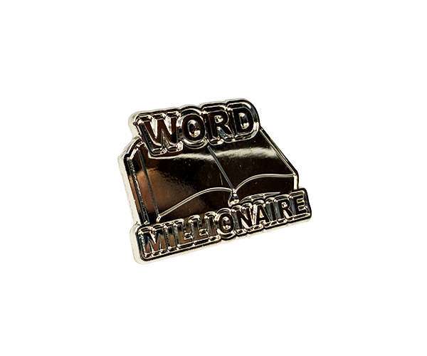 A metal badge in the shape of an open book, featuring the words “WORD MILLIONAIRE” in raised lettering across the top and bottom, from the Word Millionaire Badges collection.