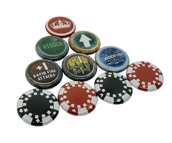 Ten 25mm Personalised Games Counters, featuring a mix of poker chip designs and custom text or symbols like "HIDDEN," "OBSERVER," arrows, and warning signs, are arranged on a white background.