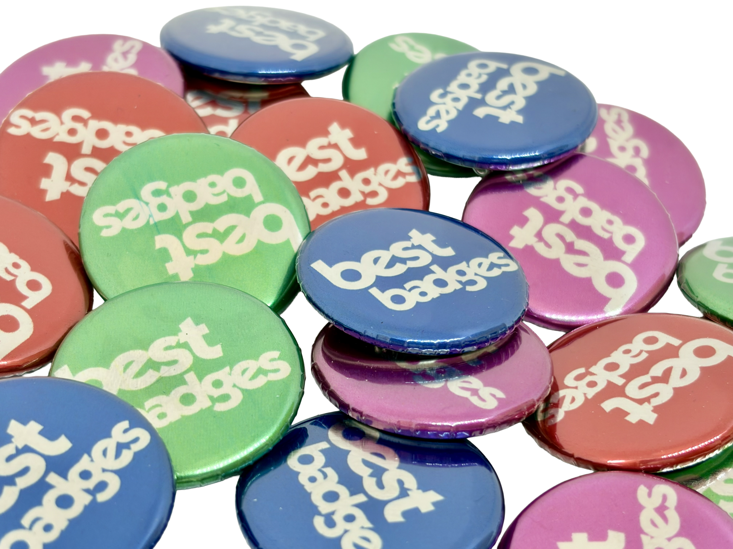 A collection of vibrant, round Metallic Button Badges featuring "best badges" printed in white on blue, green, red, and purple backgrounds—ideal for anyone wanting to design your own Button Badge.