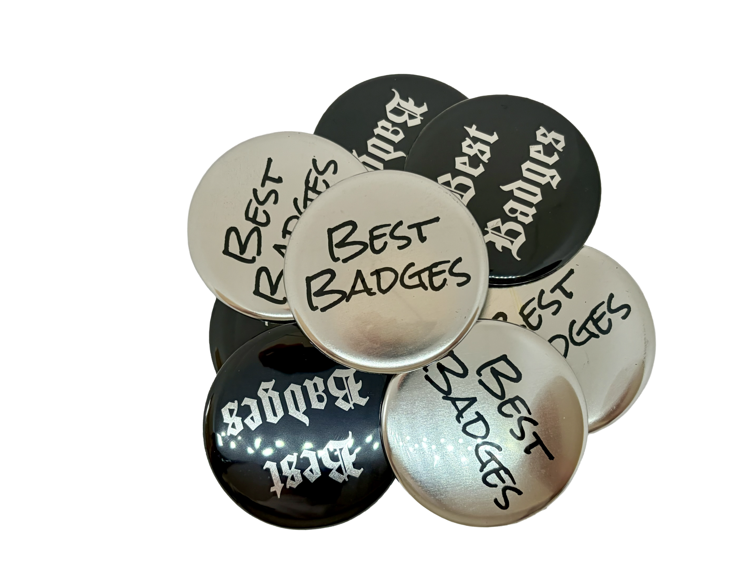 A collection of Metallic Button Badges featuring "Best Badges" in black text on silver badges and in white text on black badges, all displayed against a white background—perfect inspiration for designing your own button badge.