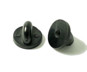 Two black plastic toggle buttons, one upright showing a central loop, the other lying flat displaying its hollow base, both on a white surface.