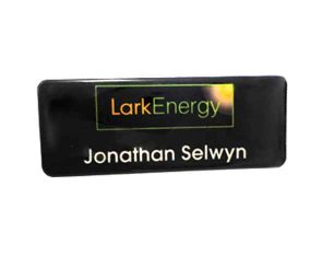 A black name badge with the Lark Energy logo and the name "Jonathan Selwyn" printed in white text.