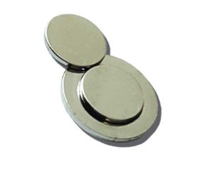 Three round, flat, silver-colored button batteries are stacked and overlapping on a plain white background.